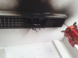A picture showing a close up of a lighting fitting that has burned the unit and the wall, which has since been rectified by an emergency electrician at London Electricians