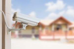 An image of a white CCTV camera mounted on the side of a building