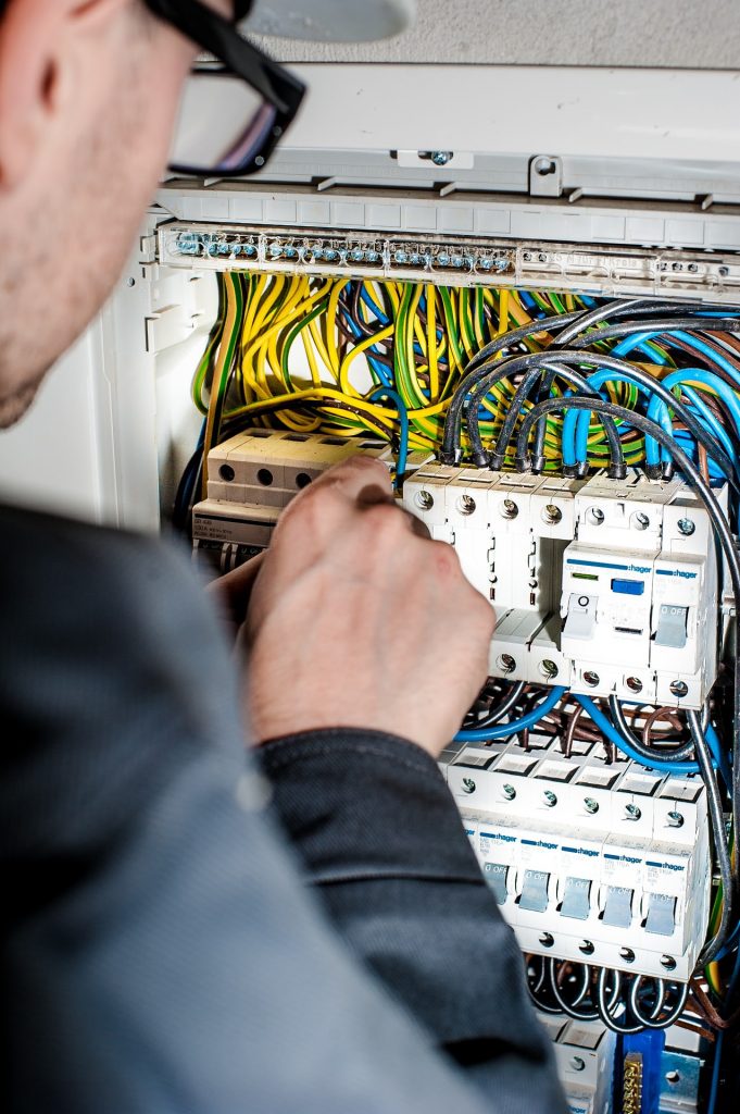 An electrician working with precision - one of the fundamental traits required to become an electrician