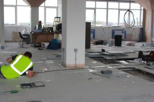 An image of electricians working on the wiring in a commercial property's floors