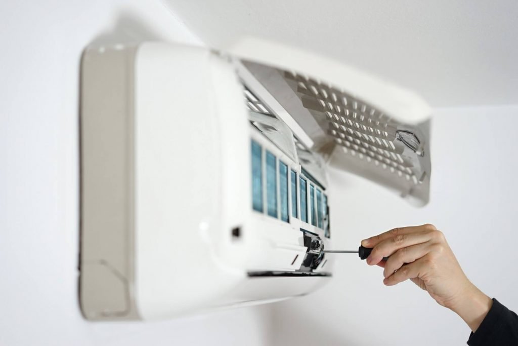 Picture of a worker carrying out air conditioning repair