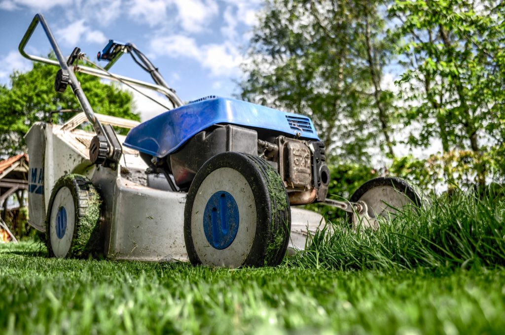 An image showing a lawnmower cutting grass