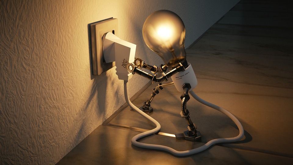 An image of a plug socket, providing electricity to a light bulb.