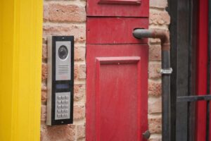 Communal video intercom and keypad beside the entrance of a London building