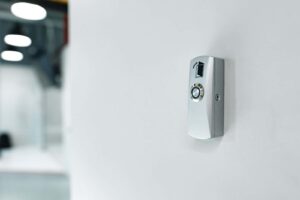 Wall-mounted door-release button used with an intercom access system